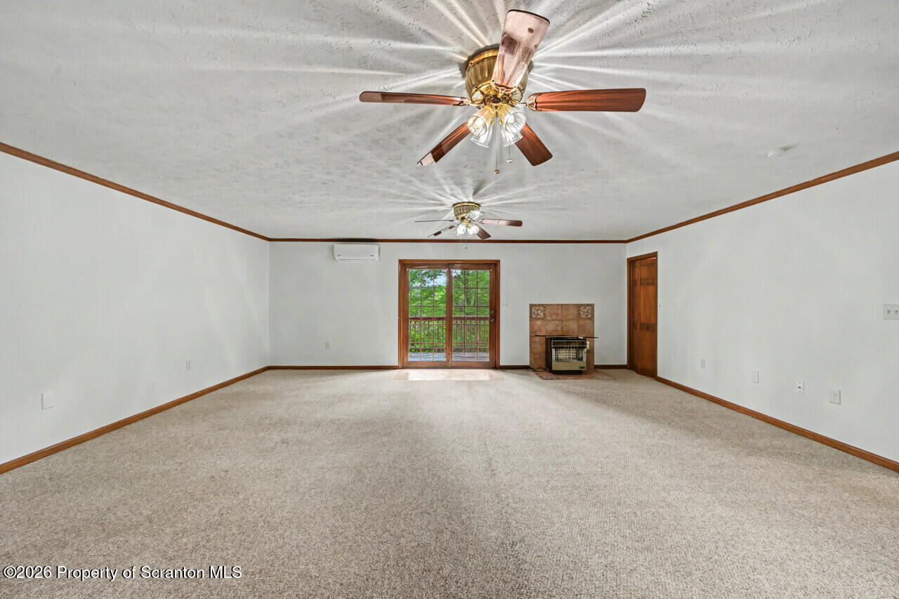 211 Buckingham Street Moscow, PA 18444 - Photo 37 of 83 a view of a livingroom with a ceiling fan and window