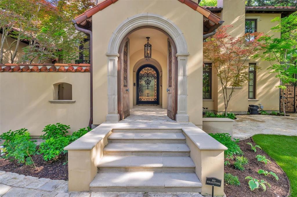4612 Watauga Road Dallas, TX 75209 - Photo 11 of 32 The property features a grand arched entryway with a solid wood door and intricate wrought iron details