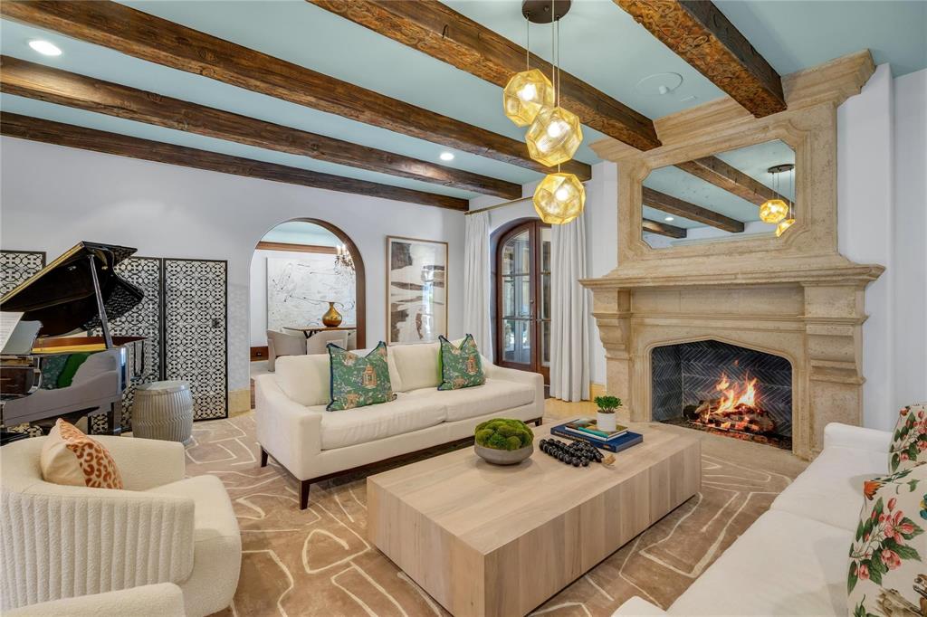 4612 Watauga Road Dallas, TX 75209 - Photo 14 of 32 The living area features a grand stone fireplace, exposed wooden ceiling beams, and arched entryways