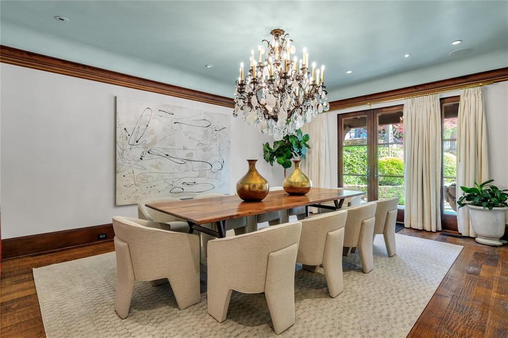 4612 Watauga Road Dallas, TX 75209 - Photo 15 of 32 Elegant dining area featuring hardwood floors, a crystal chandelier, and large windows with exterior views