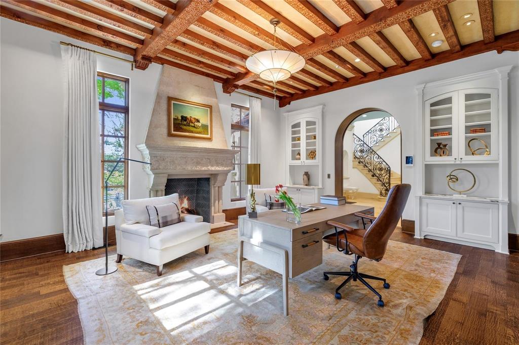 4612 Watauga Road Dallas, TX 75209 - Photo 16 of 32 This refined space features a substantial stone fireplace, rich hardwood floors, and a distinctive wood beam ceiling