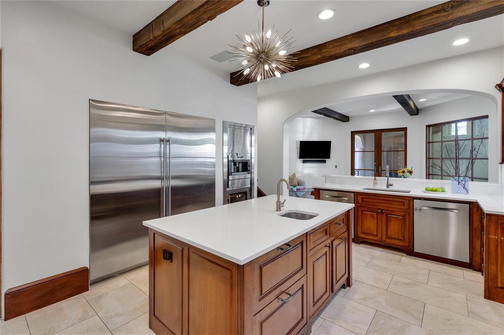 4612 Watauga Road Dallas, TX 75209 - Photo 19 of 32 The property features a spacious kitchen with a large kitchen island, stainless steel appliances, wood beam ceilings, and recessed lighting