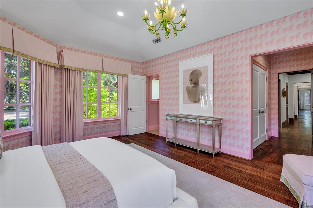 4612 Watauga Road Dallas, TX 75209 - Photo 28 of 32 The room features hardwood floors, light pink patterned wallpaper, and a decorative ceiling light fixture