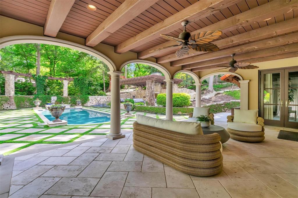 4612 Watauga Road Dallas, TX 75209 - Photo 5 of 32 Expansive covered patio featuring an exposed beam ceiling, two ceiling fans, and arched columns