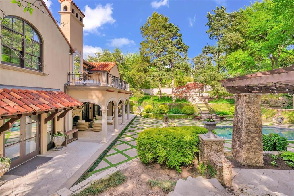 4612 Watauga Road Dallas, TX 75209 - Photo 8 of 32 The property features a stucco exterior with a red tile roof and a second-story balcony