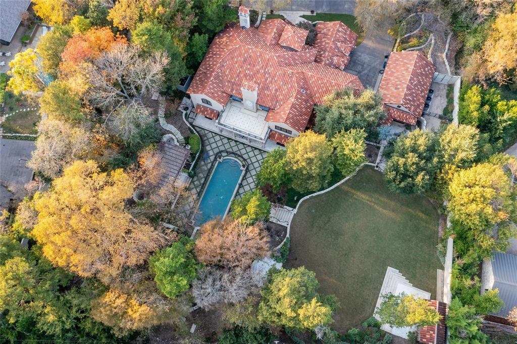 4612 Watauga Road Dallas, TX 75209 - Photo 9 of 32 The property features a red tile roof, an outdoor swimming pool, and a well-maintained lawn