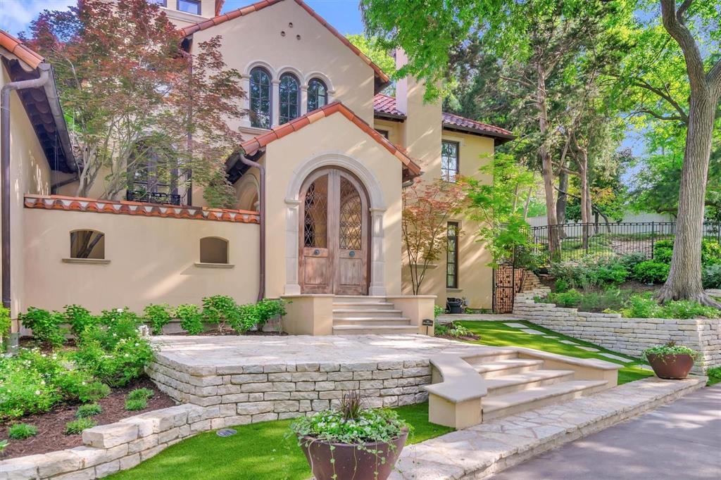 4612 Watauga Road Dallas, TX 75209 - Photo 10 of 32 The property features a stucco exterior, a tile roof, and a grand arched wooden entry door
