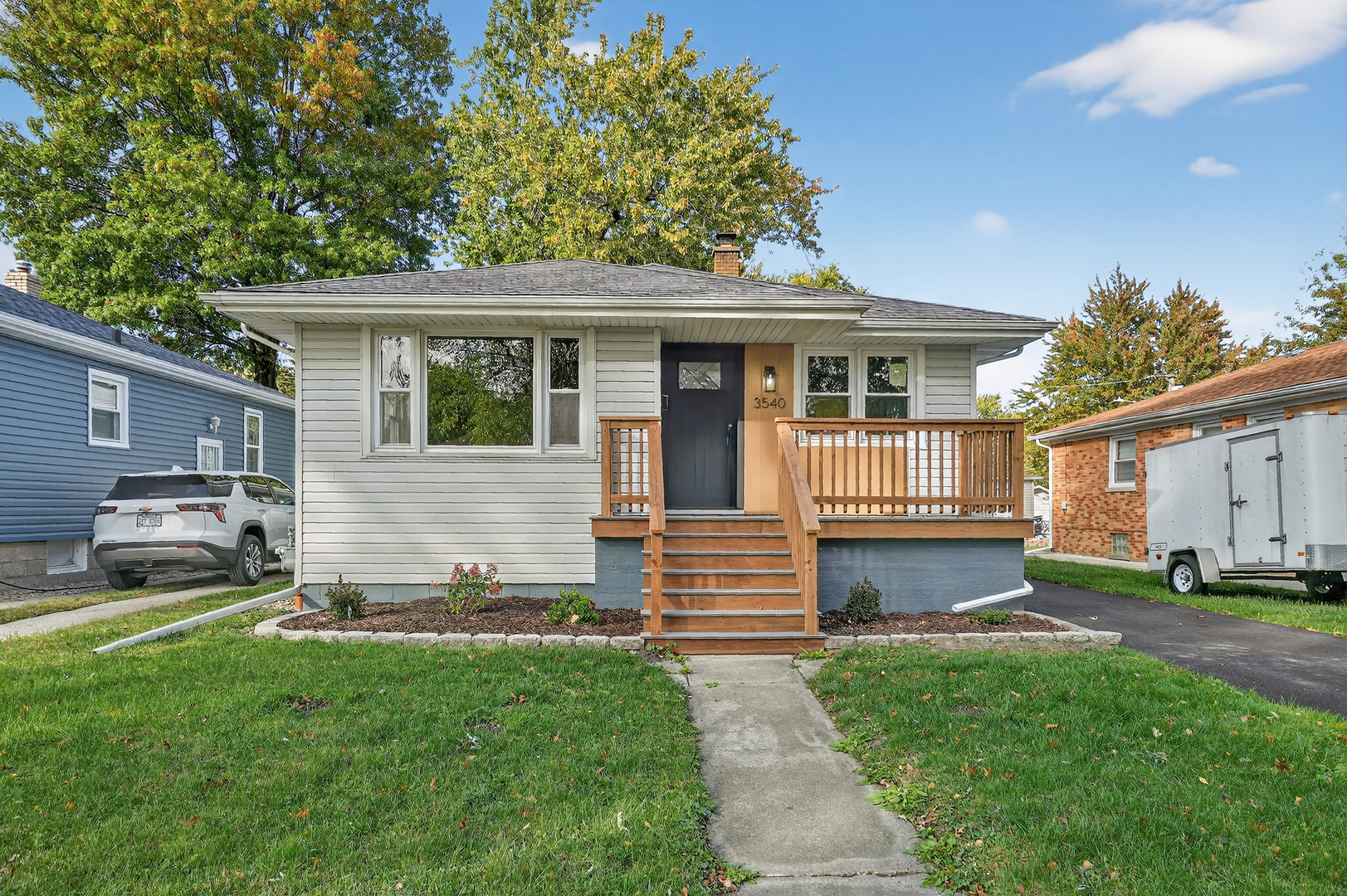 a view of a house with a yard and sitting area