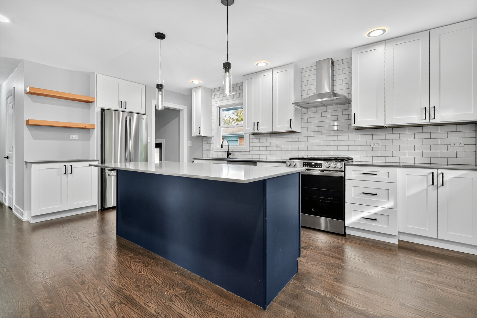 3540 Madison Street Lansing, IL 60438 - Photo 4 of 29 a kitchen with stainless steel appliances granite countertop a refrigerator a sink dishwasher a stove and white cabinets with wooden floor