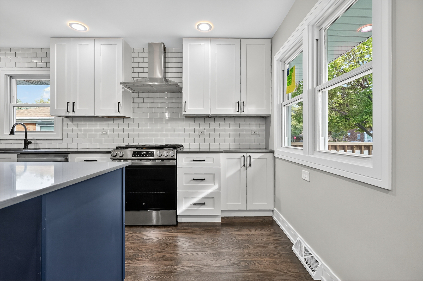 3540 Madison Street Lansing, IL 60438 - Photo 5 of 29 a kitchen with stainless steel appliances granite countertop a sink a stove and a window