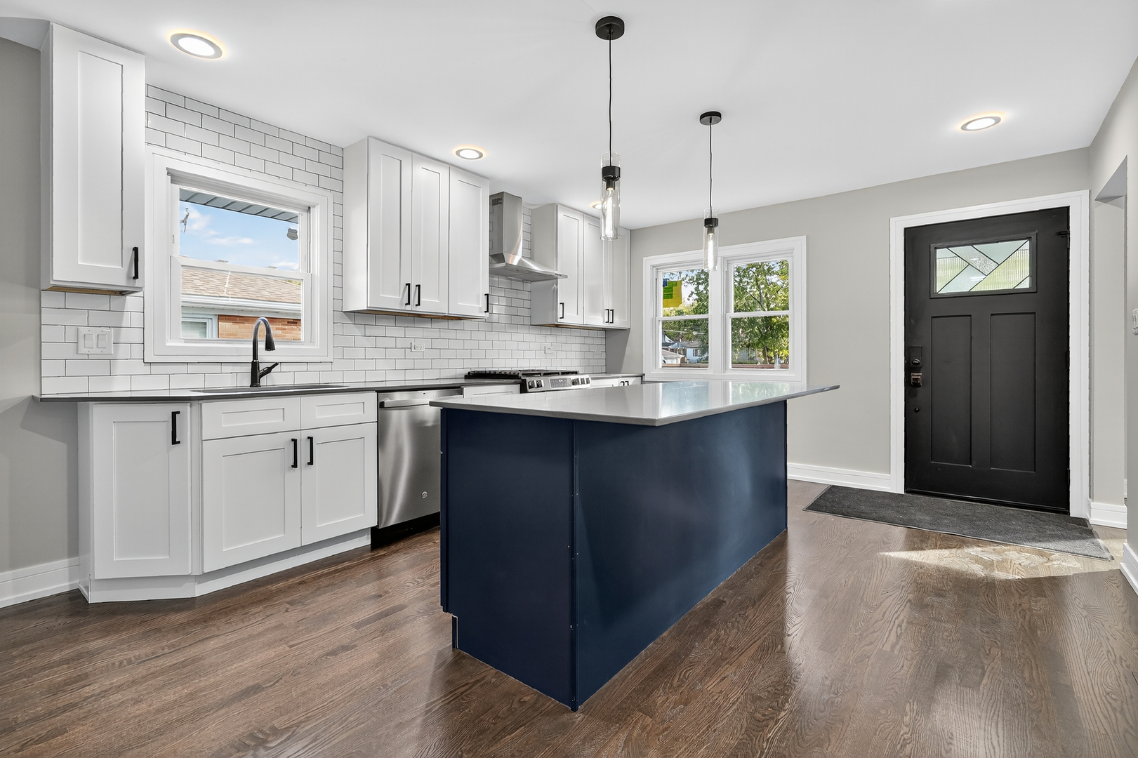3540 Madison Street Lansing, IL 60438 - Photo 9 of 29 a kitchen with kitchen island granite countertop a sink window and cabinets
