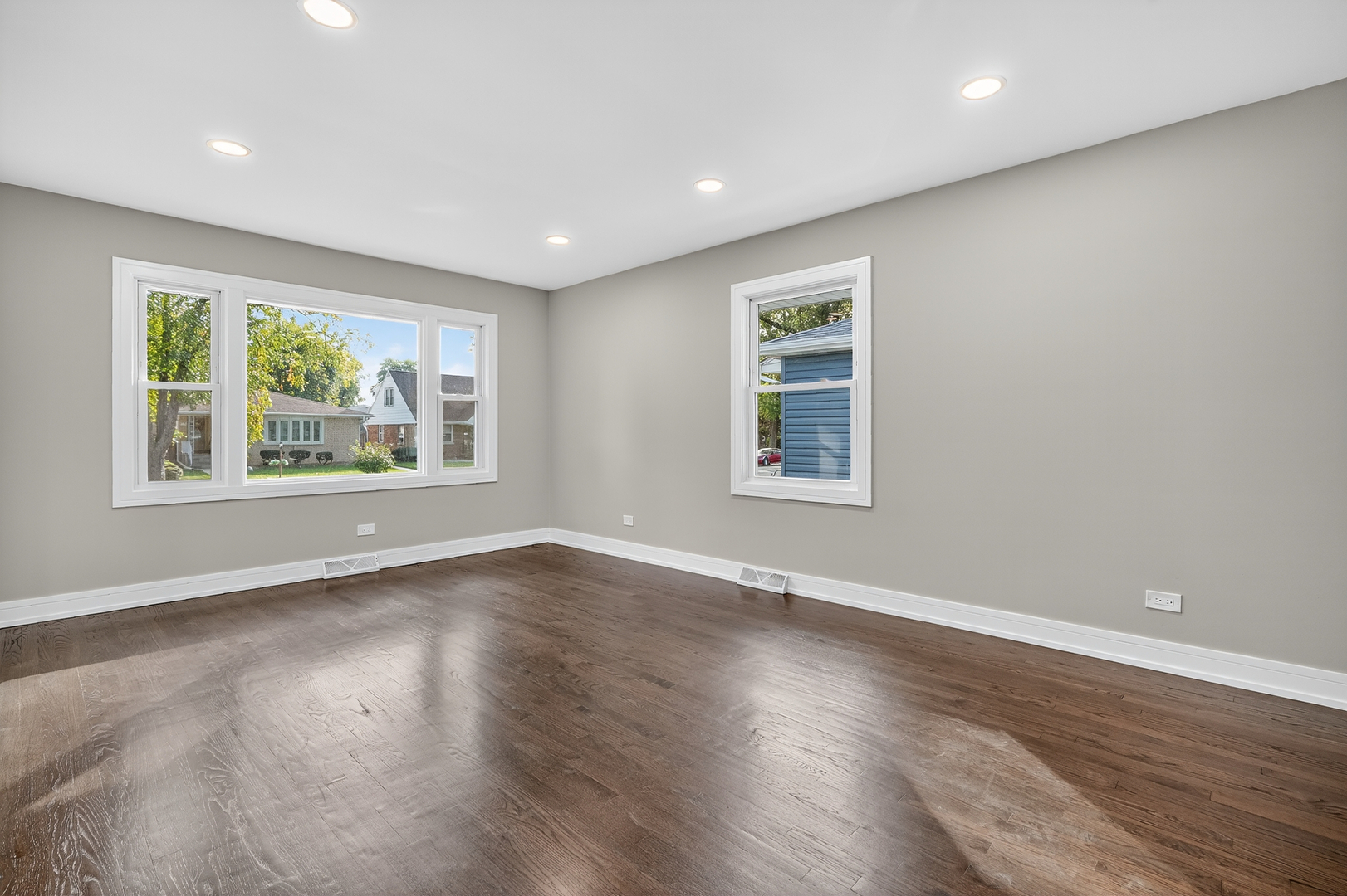 3540 Madison Street Lansing, IL 60438 - Photo 10 of 29 an empty room with wooden floor and windows