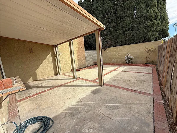 a backyard of a house with wooden floor and outdoor seating