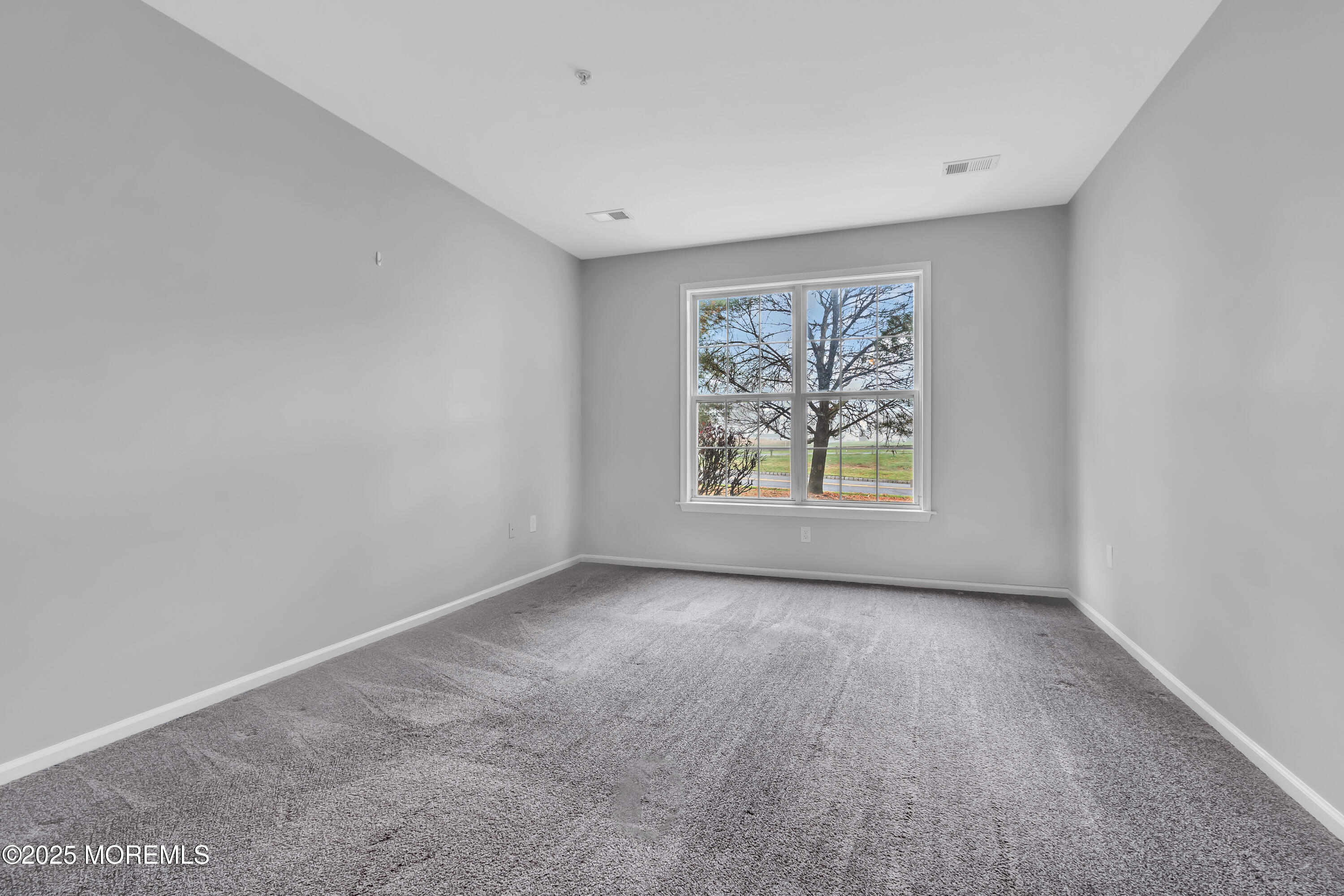 694 St Andrews Place Manalapan, NJ 07726 - Photo 12 of 26 an empty room with windows