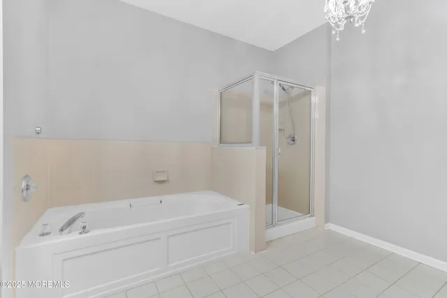 a spacious bathroom with a bathtub and shower