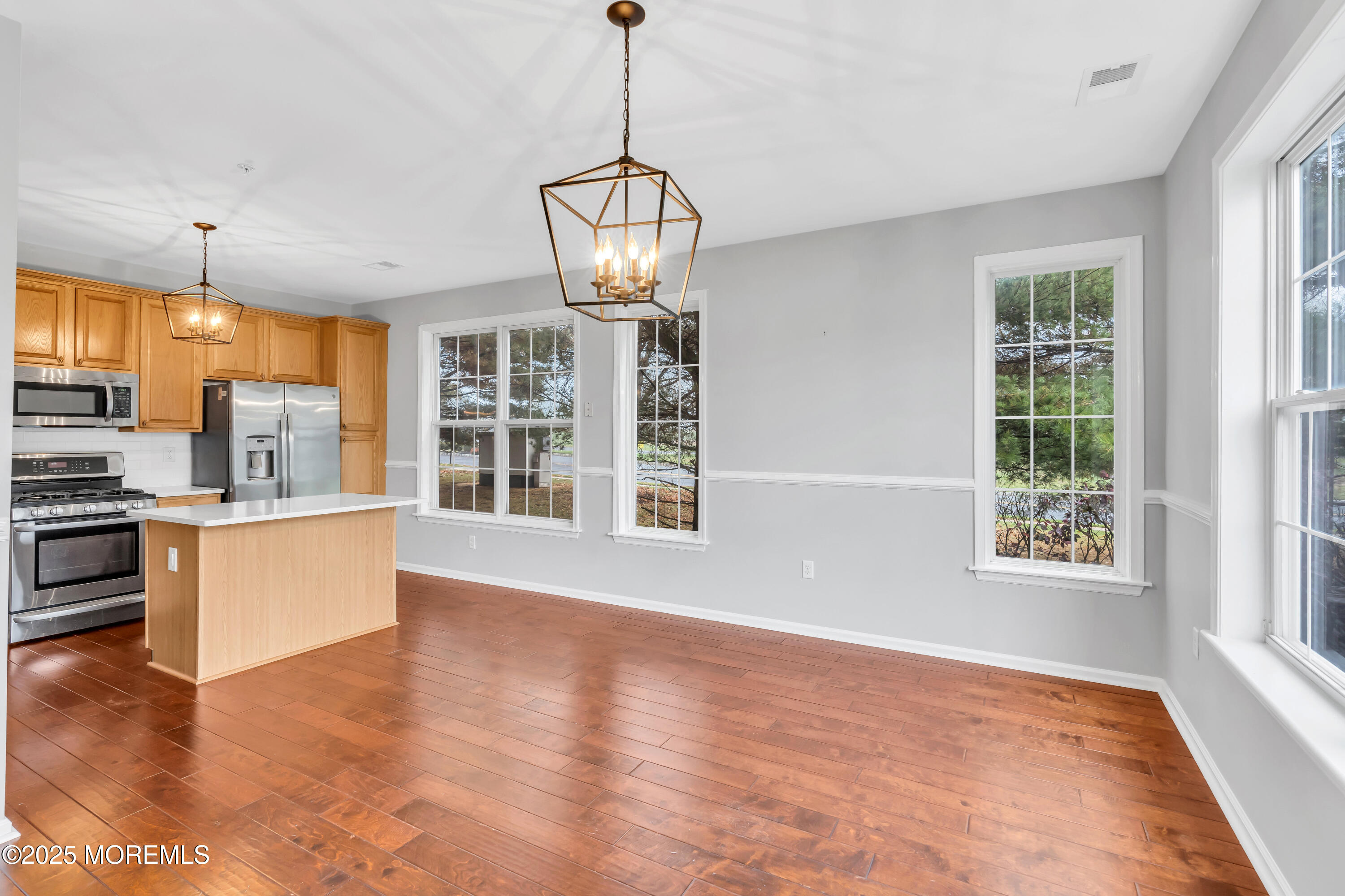 694 St Andrews Place Manalapan, NJ 07726 - Photo 20 of 26 a view of an empty room with a window and wooden floor