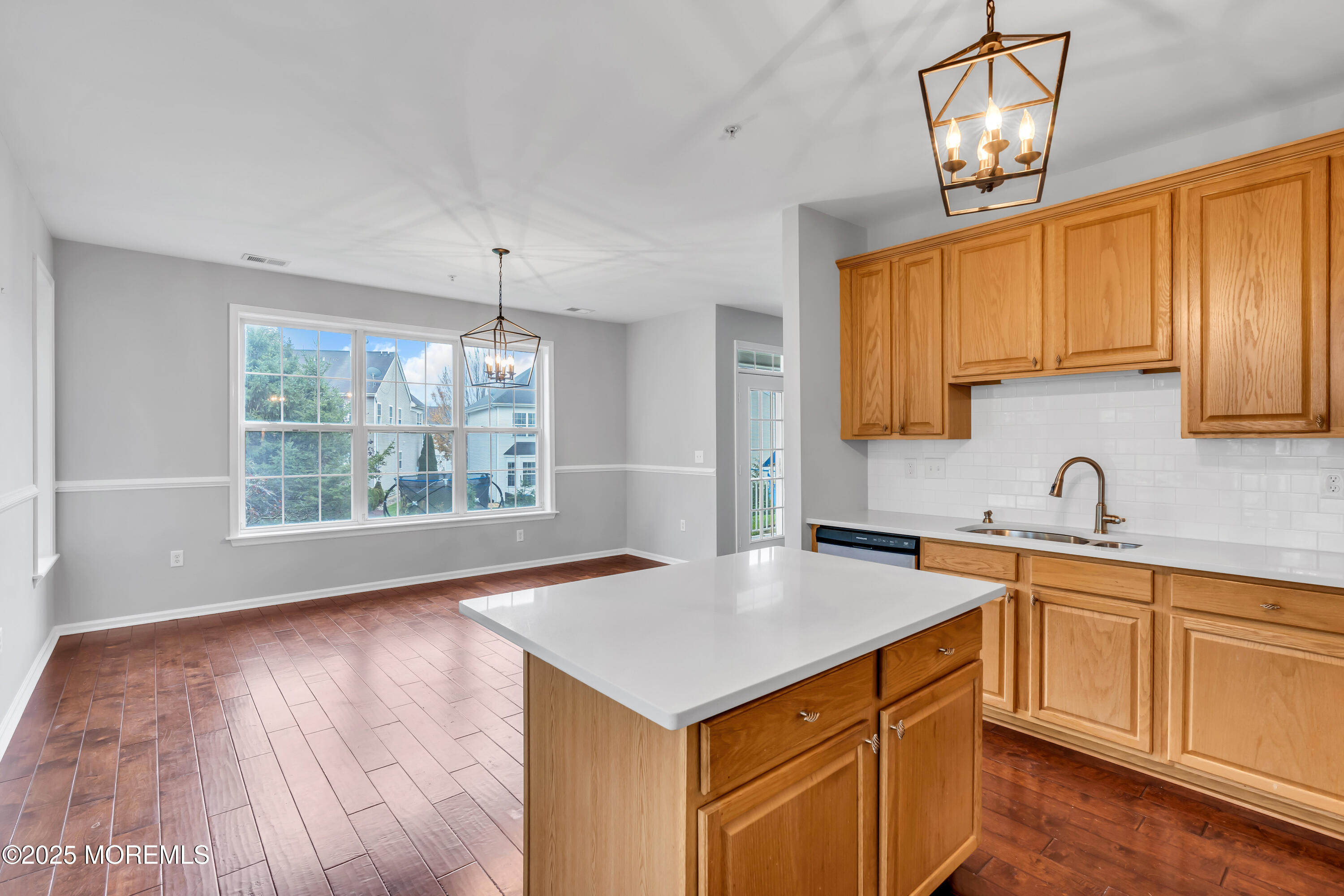 694 St Andrews Place Manalapan, NJ 07726 - Photo 23 of 26 a kitchen with a sink stove and cabinets