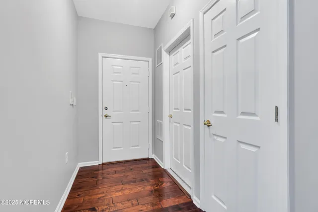 a view of a hallway with wooden floor