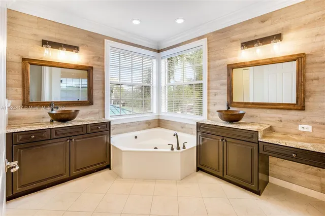 a large kitchen with a sink and large window