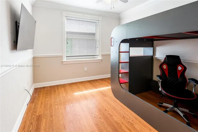 a view of a room with wooden floor and furniture