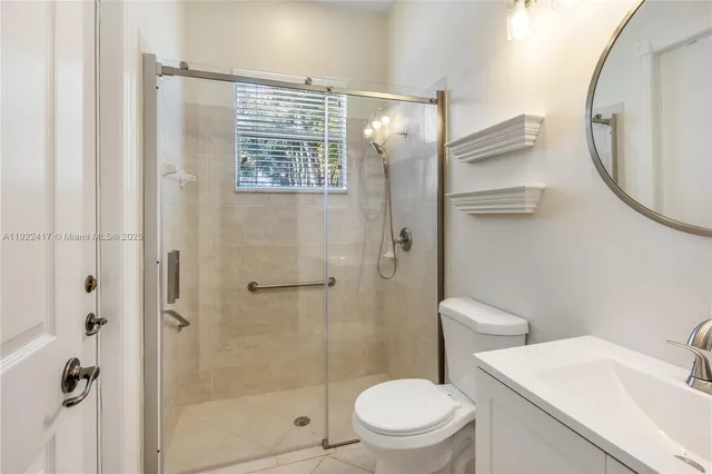 a white toilet sitting next to a bathroom sink