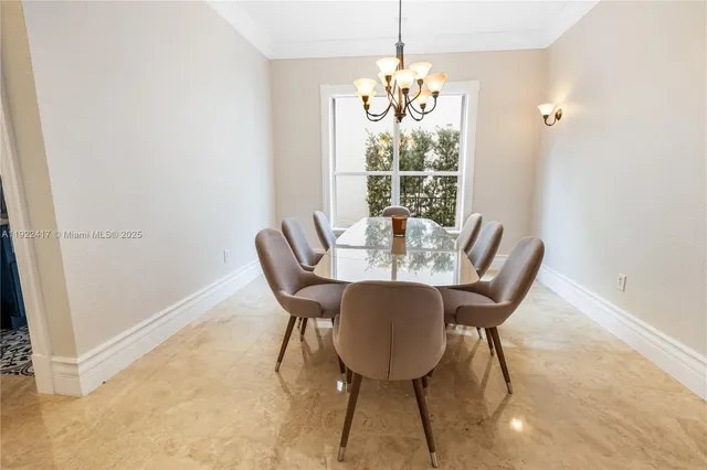 a view of a dining room with furniture wooden floor and chandelier