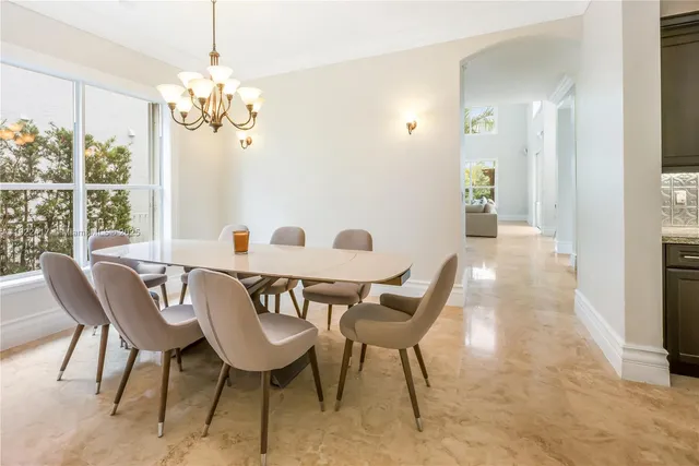 a view of a dining room with furniture and chandelier