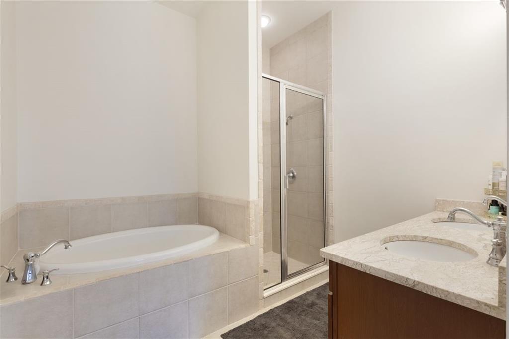 360 Chambers Street, Unit 208 Woodstock, GA 30188 - Photo 17 of 46 a bathroom with a granite countertop sink and a bathtub
