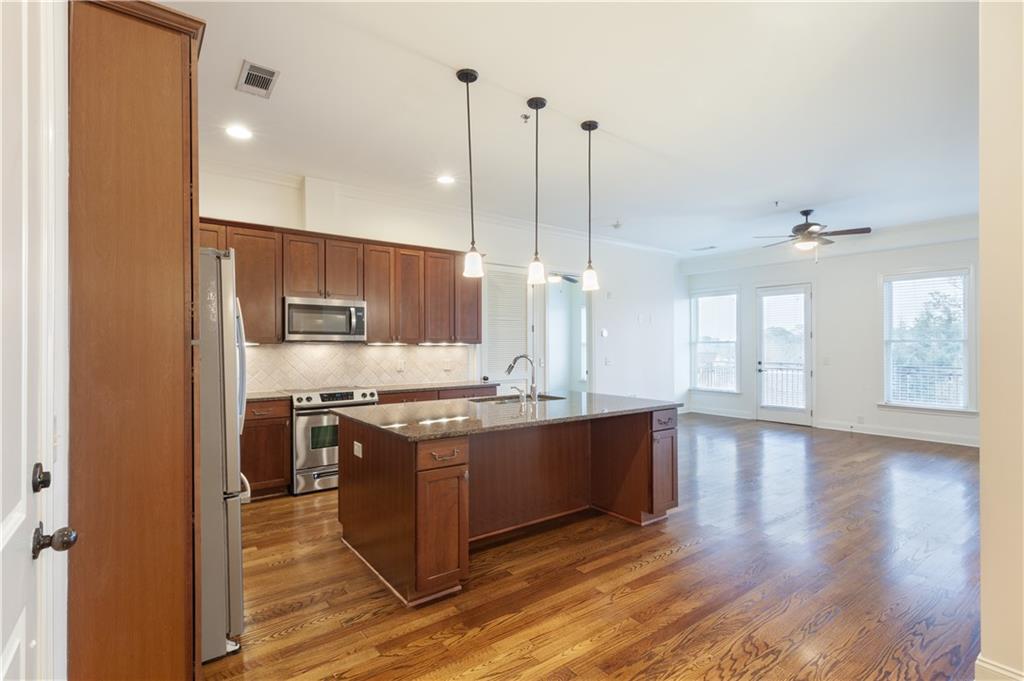 360 Chambers Street, Unit 208 Woodstock, GA 30188 - Photo 2 of 46 a kitchen with stainless steel appliances granite countertop a stove a sink and a refrigerator