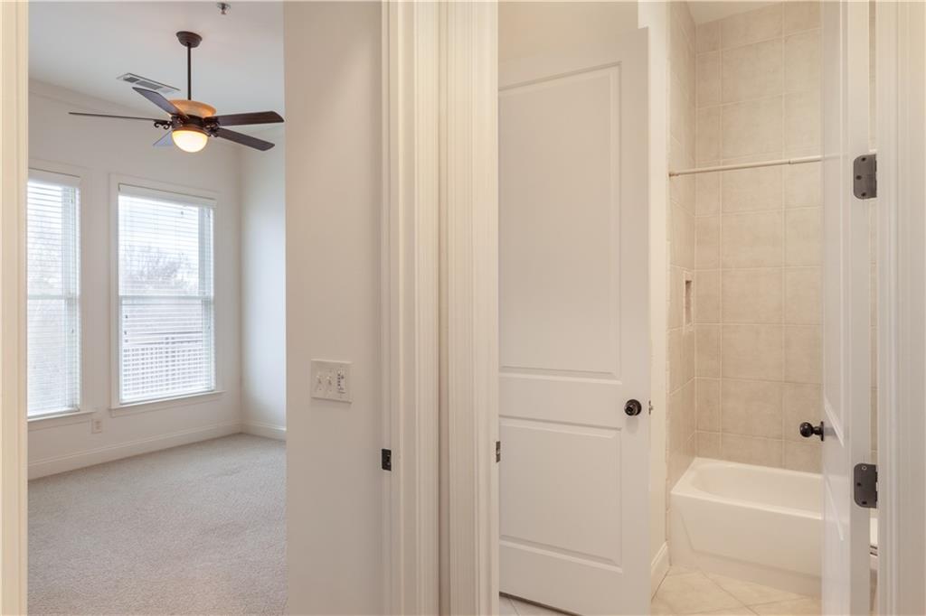 360 Chambers Street, Unit 208 Woodstock, GA 30188 - Photo 23 of 46 a bathroom with a bathtub and shower
