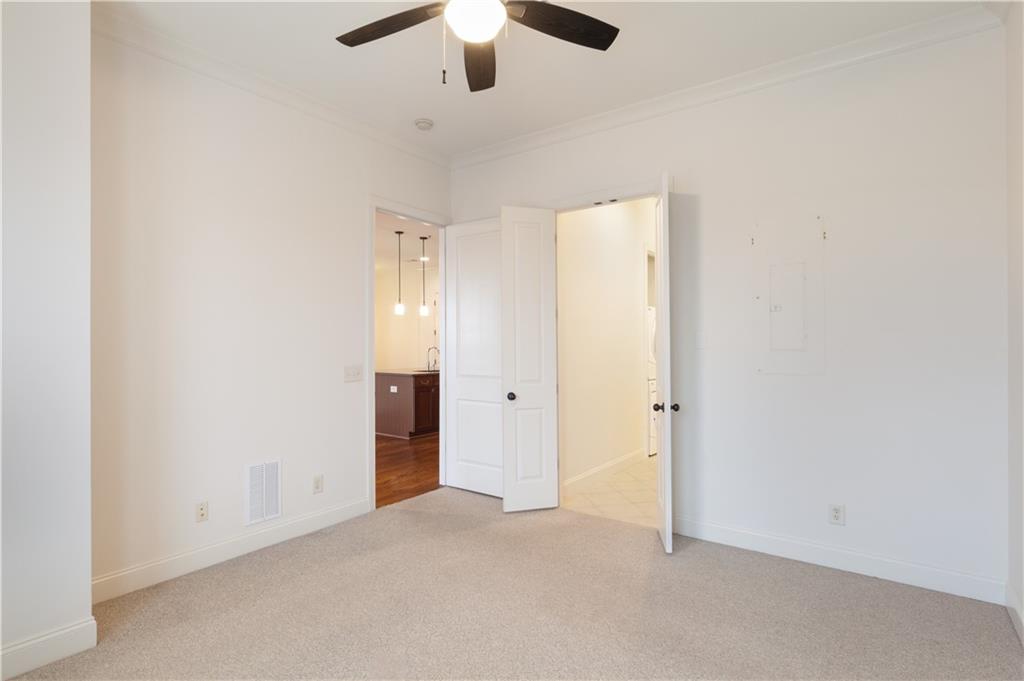 360 Chambers Street, Unit 208 Woodstock, GA 30188 - Photo 30 of 46 an empty room with chandelier fan