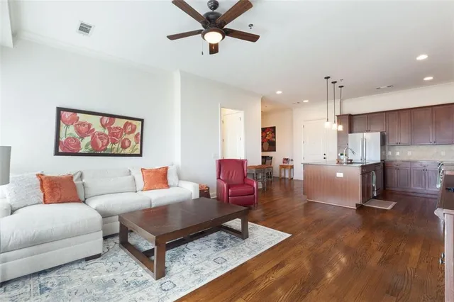 a living room with furniture and kitchen view