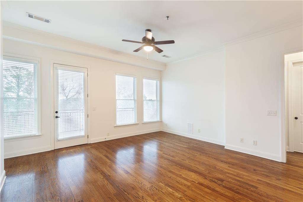 360 Chambers Street, Unit 208 Woodstock, GA 30188 - Photo 4 of 46 wooden floor in an empty room with a window