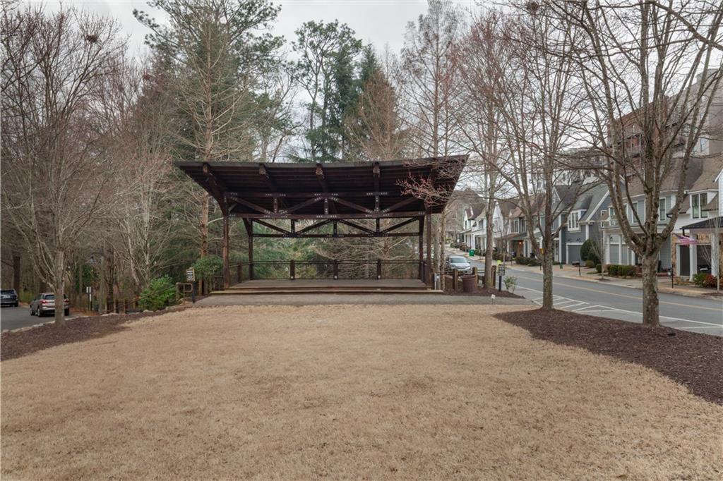 360 Chambers Street, Unit 208 Woodstock, GA 30188 - Photo 43 of 46 a view of a street with a bench and trees