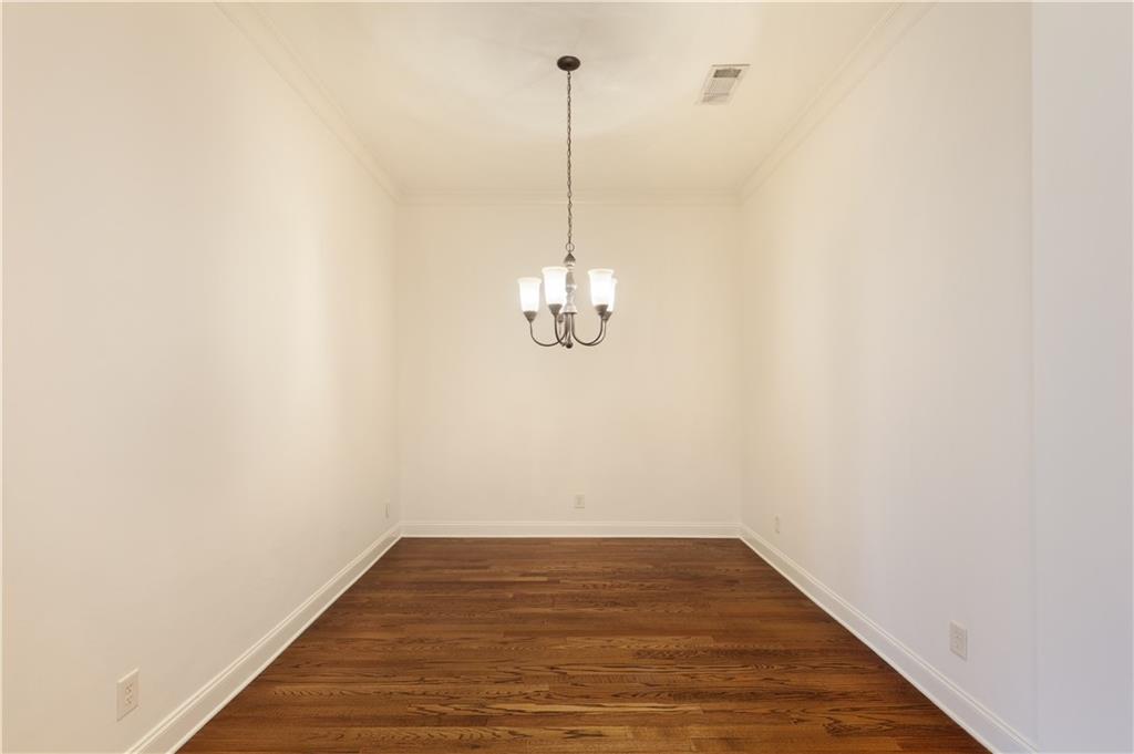 360 Chambers Street, Unit 208 Woodstock, GA 30188 - Photo 7 of 46 a view of a room with wooden floor and a ceiling fan