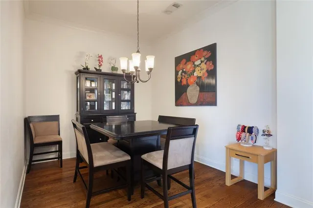 a view of a dining room with furniture wooden floor and a chandelier