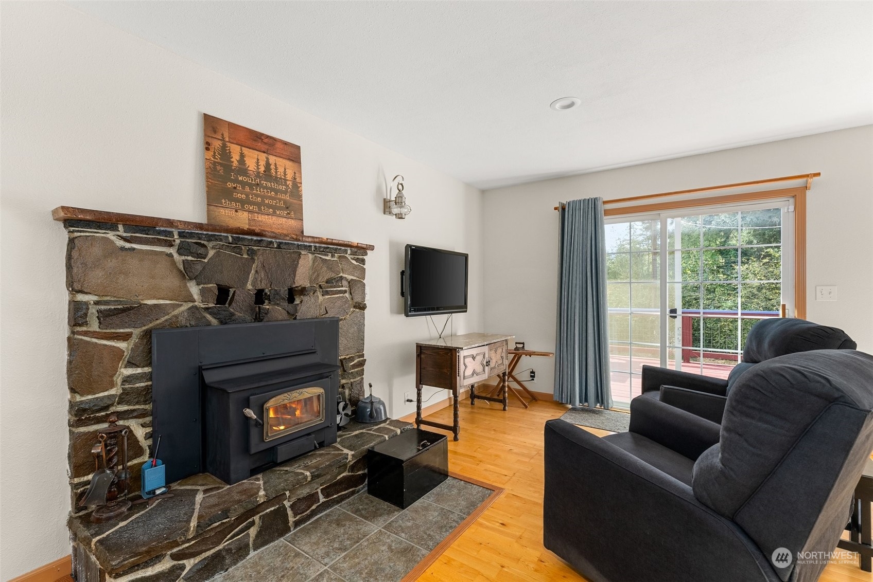 158 Hawkins Road Winlock, WA 98596 - Photo 10 of 28 a living room with furniture a flat screen tv and a fireplace