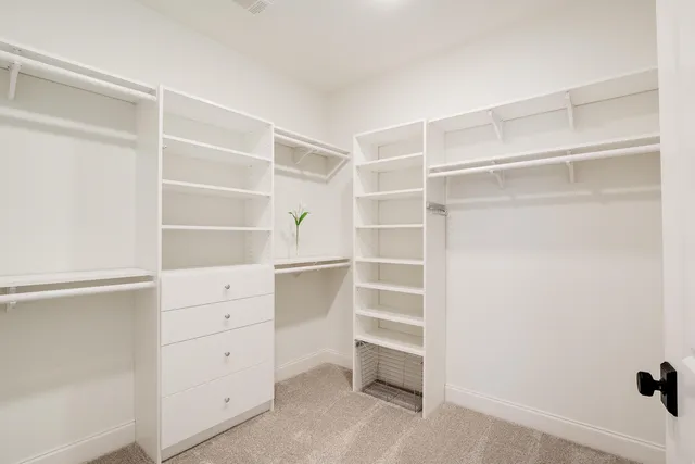 a bedroom with a bed and a ceiling fan