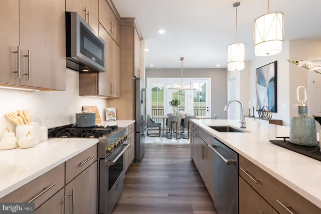 a kitchen with a sink stove top oven and cabinets