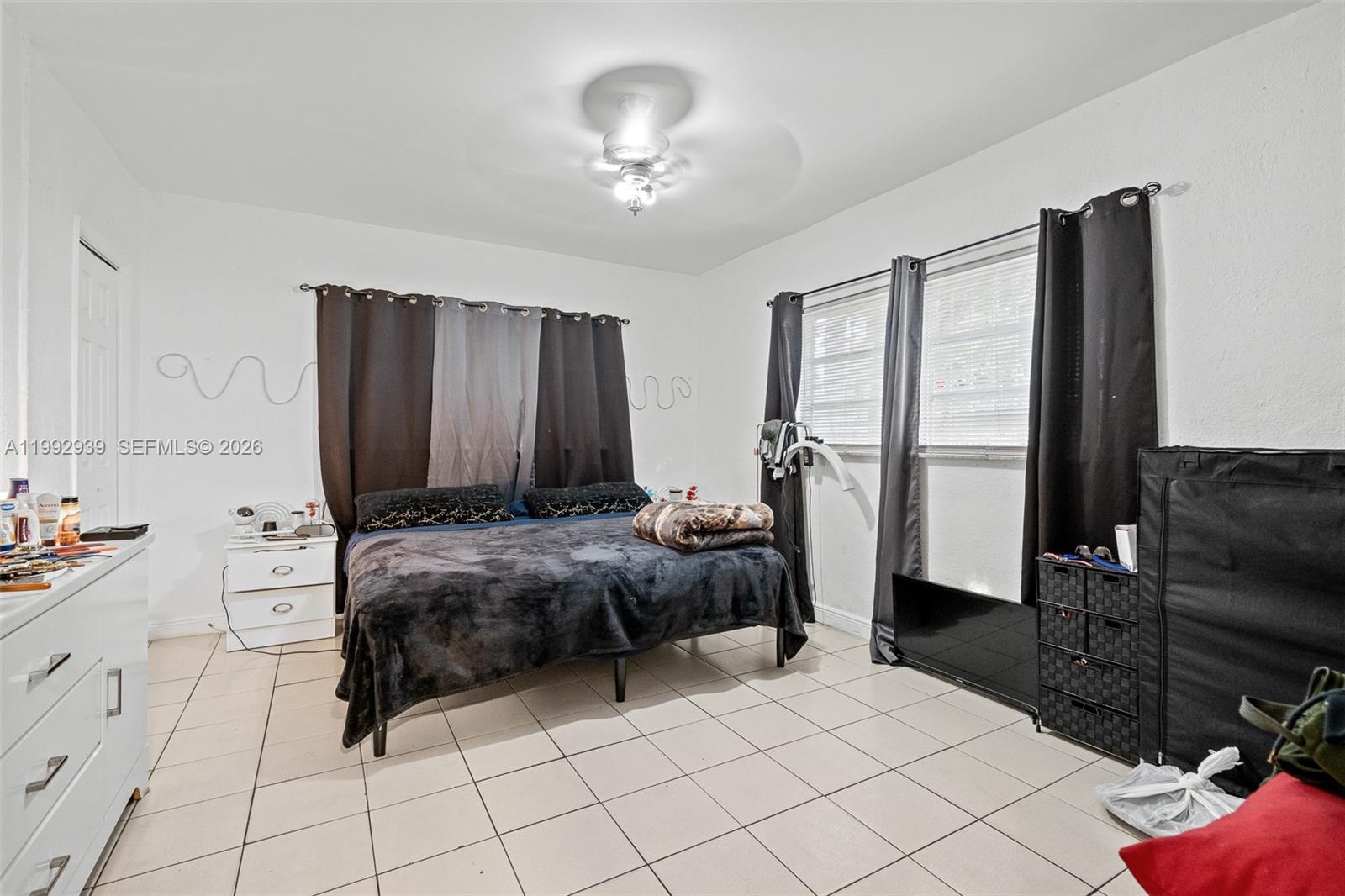 1262-1264 Northwest 46th Street Miami, FL 33142 - Photo 6 of 13 a spacious bedroom with a bed and a dresser in it