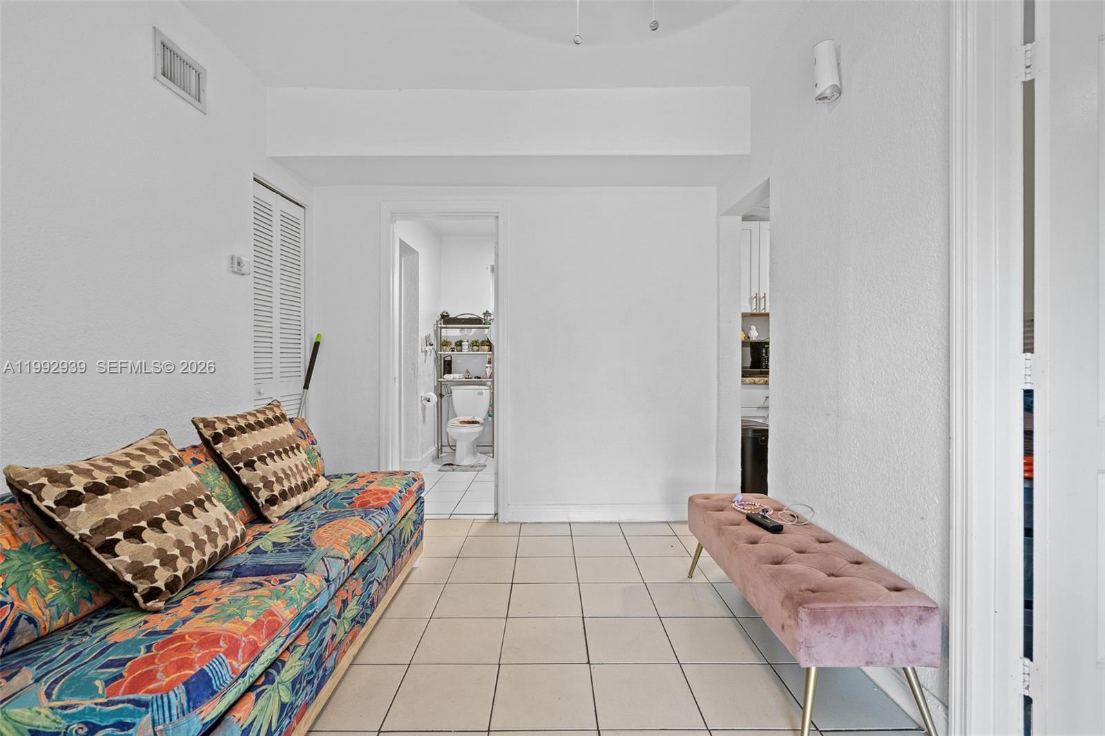 1262-1264 Northwest 46th Street Miami, FL 33142 - Photo 7 of 13 a bedroom with furniture and a book shelf