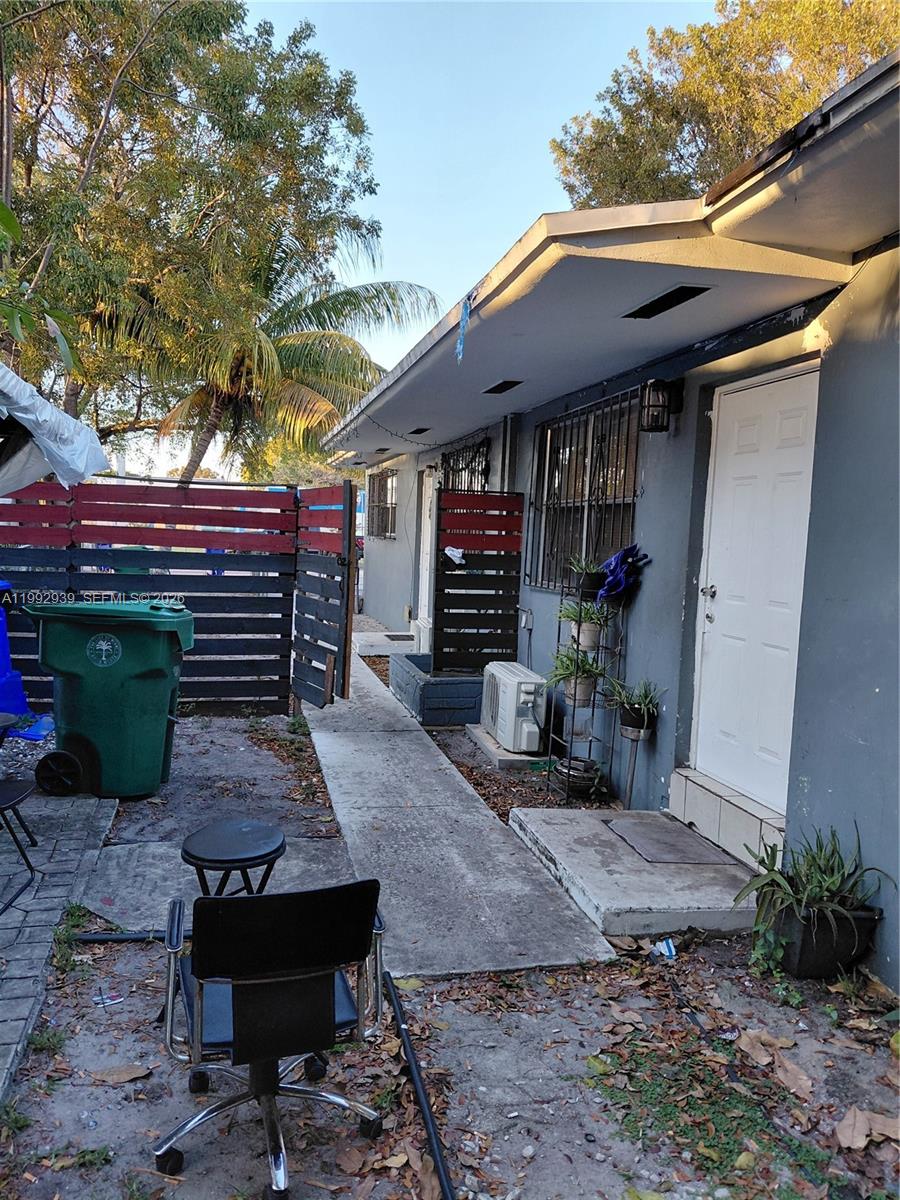 1262-1264 Northwest 46th Street Miami, FL 33142 - Photo 10 of 13 a view of a chairs and table in backyard
