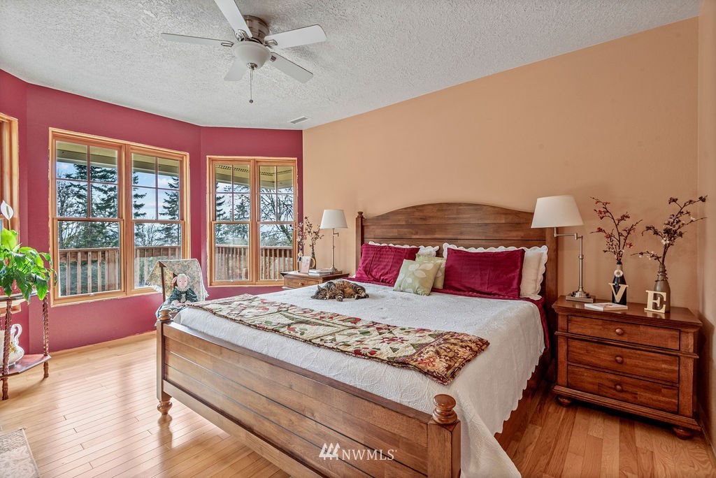 212 Whitewater Road Longview, WA 98632 - Photo 24 of 39 a bedroom with a bed and wooden floor