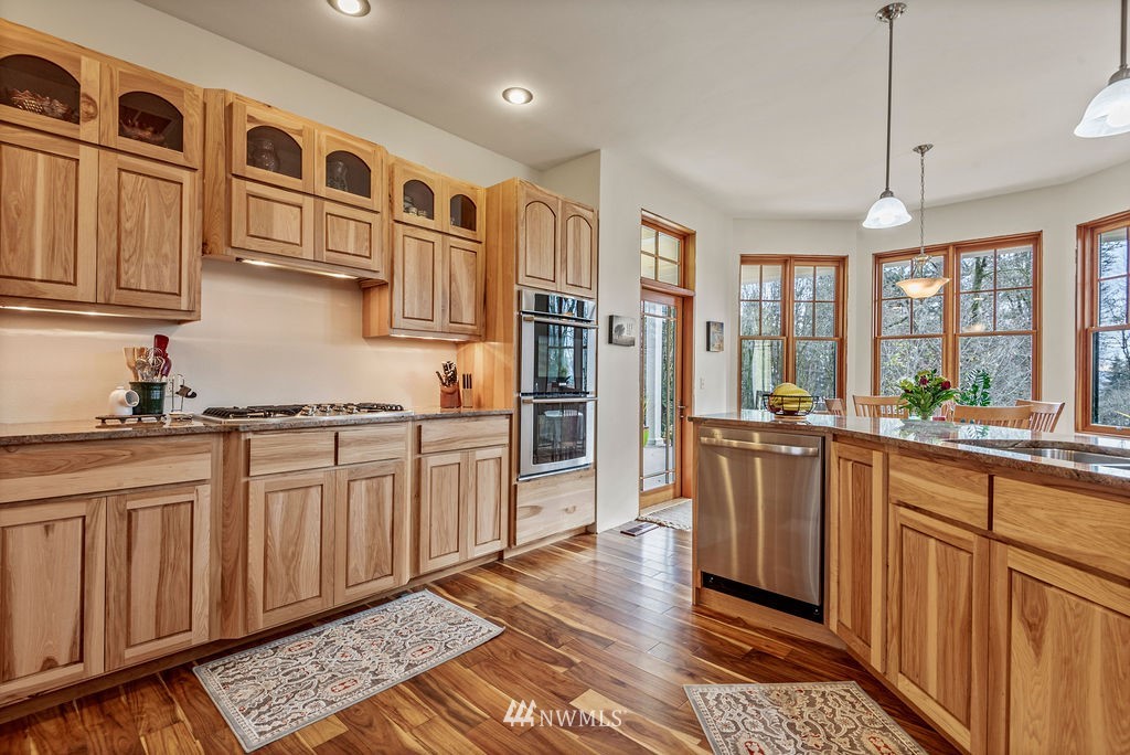 212 Whitewater Road Longview, WA 98632 - Photo 10 of 39 a kitchen with stainless steel appliances granite countertop a refrigerator and wooden cabinets