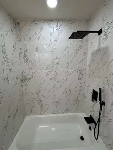 a utility room with a sink a vanity and mirror