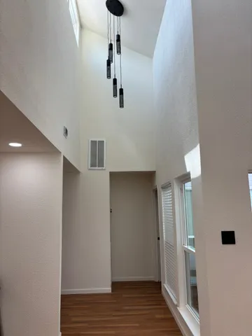 a view of a hallway with wooden floor