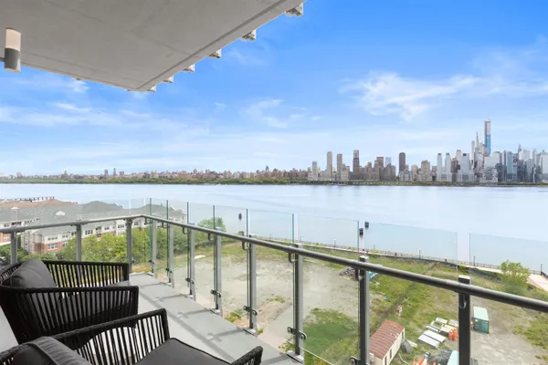 a view of a balcony with lake view and wooden floor