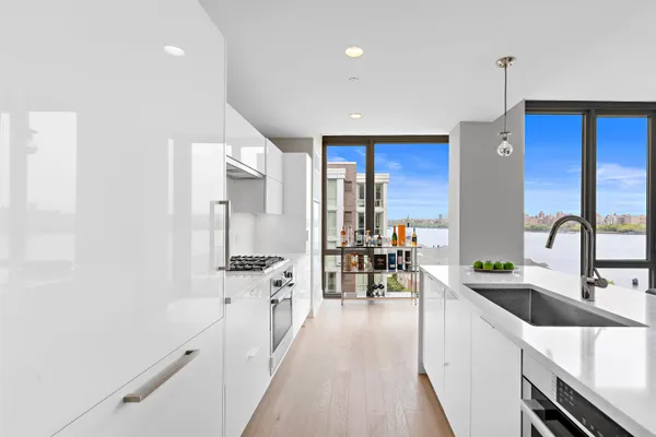a kitchen with stainless steel appliances a sink stove and cabinets
