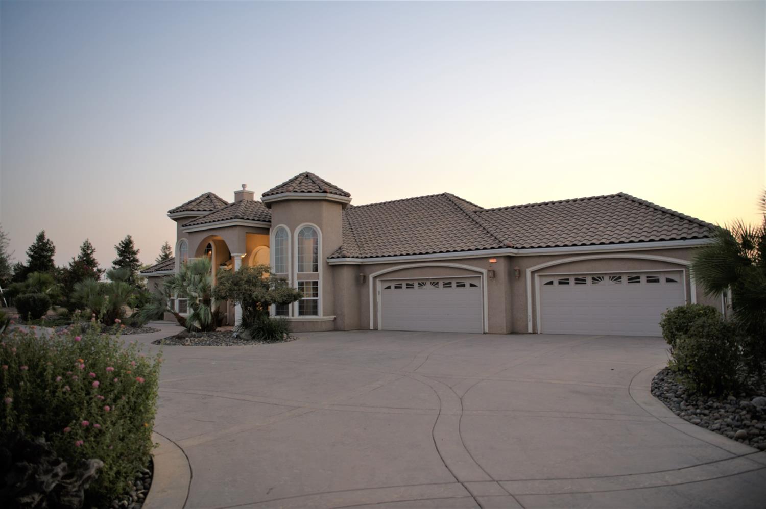 21196 Steward Road Madera, CA 93638 - Photo 3 of 39 a view of a house with a big yard and large windows