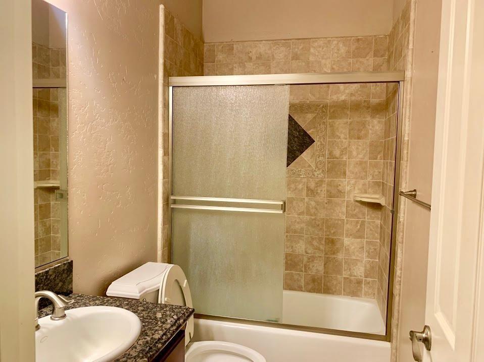 21196 Steward Road Madera, CA 93638 - Photo 31 of 39 a bathroom with a granite countertop shower and a sink
